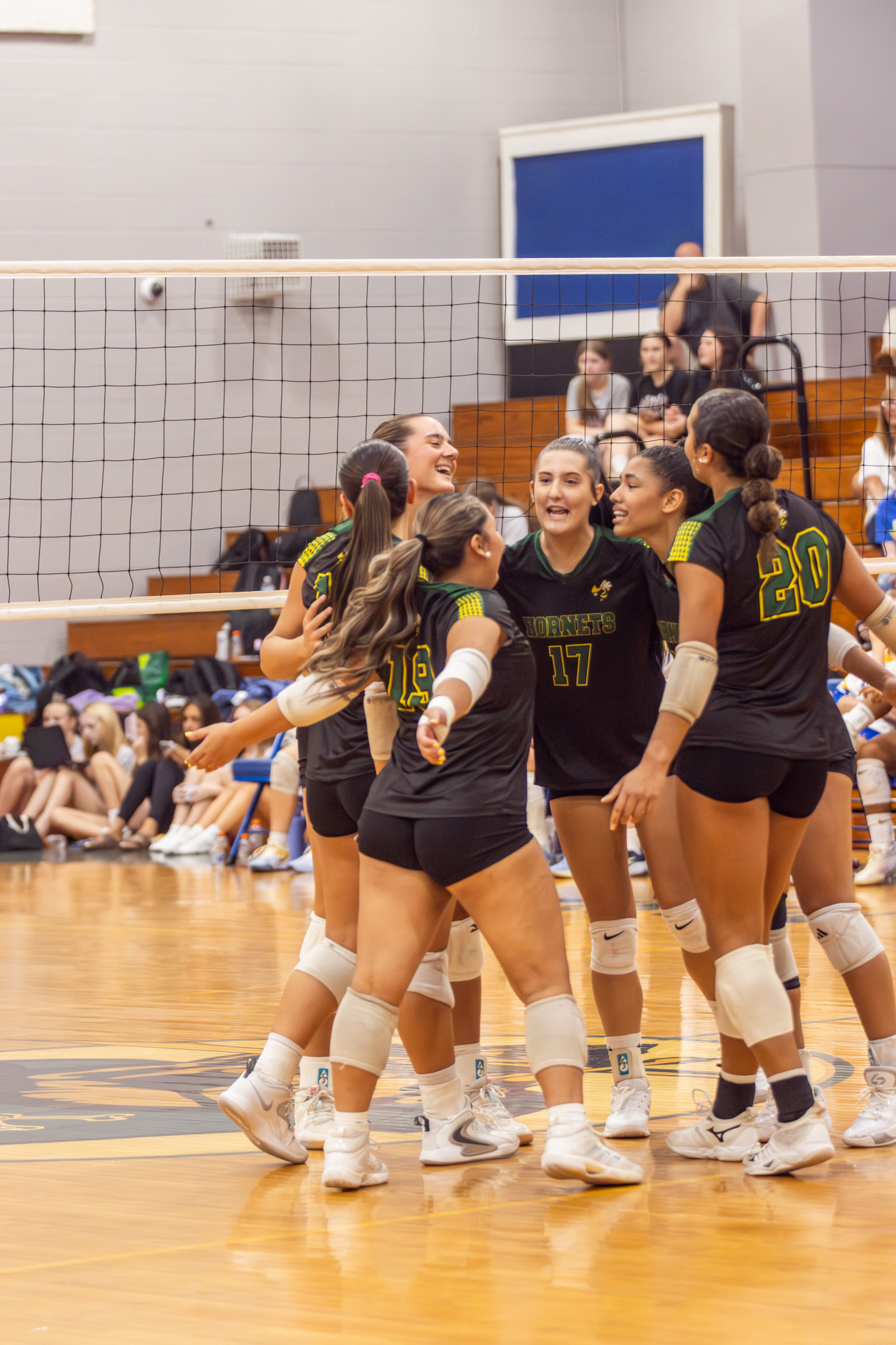Yulee High School varsity volleyball players celebrate after scoring a point against the Fernandina Beach Lady Pirates. Photo by Suzi Hamilton/For the News-Leader