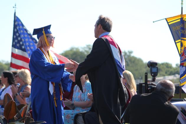 Valedictorian Kiawa Dempsey receives her diploma from Fernandina Beach High principal Chris Webber.