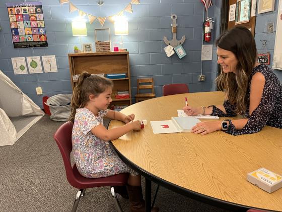 School psychologist Sarah Davis leads her daughter through an IQ test in her office with a tee-pee in the corner and filled with sensory toys to help children calm their more difficult emo-tions.