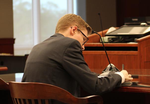 Fernandina Beach High School Senior Dillon Wagner prepares for court. Wagner volunteers his time as a prosecuting attorney for the State of Florida in Teen Court. Photo by Holly Dorman.