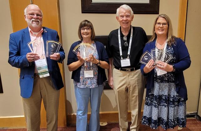 News-Leader Publisher Foy Maloy, left, displays the newspaper’s first-place awards, joined by Community Newspapers, Inc. co-owner Tom Wood and Nassau County Record reporter Kathie Sciullo and Editor and Publisher Amanda Ream, right. The News-Leader won four awards and the Record won 15. The newspapers compete in separate categories based on circulation size. Photo by Todd Wilson/special