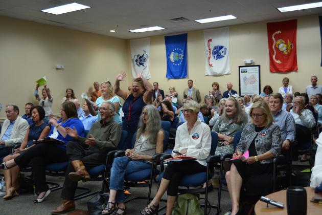 Concerned residents celebrate the County Commission’s decision to stand with its building height ordinance. Marissa Mahoney/News-Leader