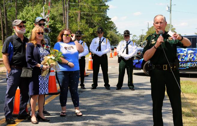 Tim Moyers removes a drape to reveal the marker dedicated to his son, fallen Nassau County Sheriff’s Deputy Joshua Moyers, Monday afternoon. Photo by Kathie Sciullo/Nassau County Record.