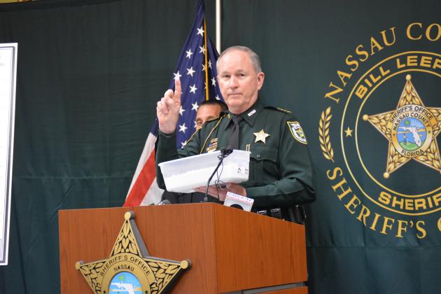 Sheriff Bill Leeper holds up a bucket of flour to demonstrate the amount of fentanyl seized in Operation Heavy Weights. Photo by Holly Dorman/News-Leader.