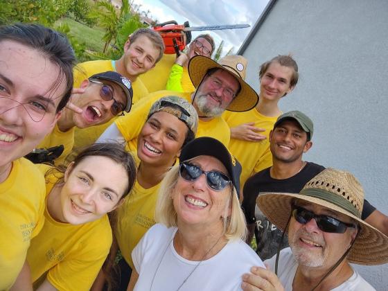 Volunteers from the Church of Jesus Christ of Latter-day Saints pose with Robert and Pam Nofye after helping dissemble their pool cage that collapsed in Hurricane Ian.