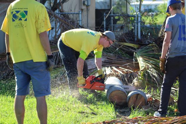 Volunteers from the Church of Jesus Christ of Latter-day Saints pull out the heavy equipment to help local homeowners clear their property of debris in Cape Coral. Cape Coral was only recently cleared for volunteers to enter after the search for survivors ended.