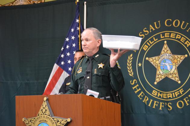 Sheriff Bill Leeper holds up a bucket of flour to demonstrate the amount of fentanyl seized in Operation Heavy Weights. Photo by Holly Dorman/News-Leader.