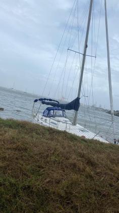 This unattended boat came loose from its moorings during the storm.
