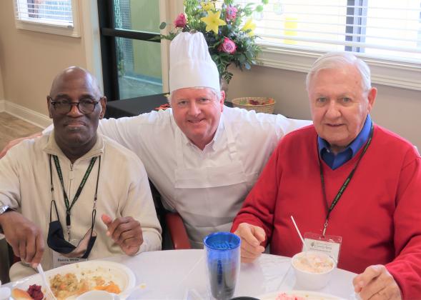 Greg Cook (center), General Manager of The Ritz-Carlton, Amelia Island, takes a moment to pose with Fernandina Beach “Just Friends” seniors Ronnie (left) and David during the annual Thanksgiving event.