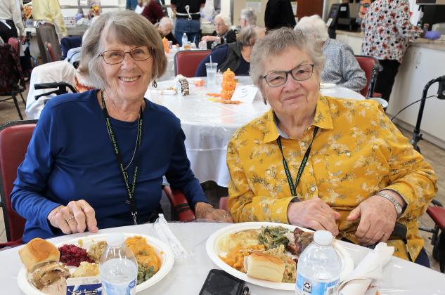 Fernandina Beach Senior Life Center “Just Friends” seniors Miss Theresa (left) and Miss Marie are ready to start the Thanksgiving meal.
