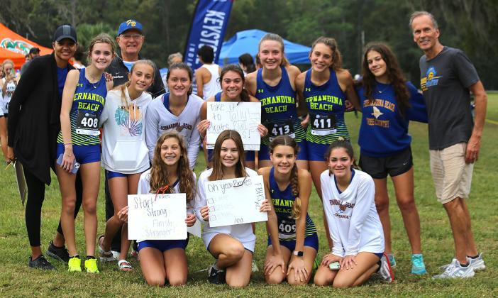 The Fernandina Beach High School girls cross country team, above, includes, front row from left, Emma Barone, Kate Chenoweth, Adalai Kwiatkowski and Grace Scuderi; back row, assistant coach Melanie Wright, Emma Gunn, assistant coach Roy Benson, Mikaela Nichols, Juliana Ferus, Aislinn Bell, Lauren Quinn, Callie Nesbitt, Bo Gatti and head coach Dave Reinhart. Pictured, below from left, are Nesbitt, Bell and Quinn, and Nichols.