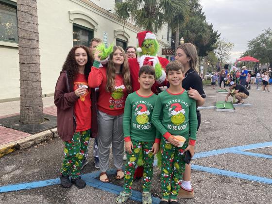 Oh the WHO-manity! The Cornell Family posed for a Grinchy pic at the Black Friday Pajama Party in downtown Fernandina Beach. Photo by Tracy Dishman