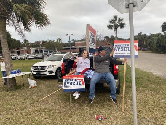 Election supporters wave at voters as they turn into Atlantic Rec Center.