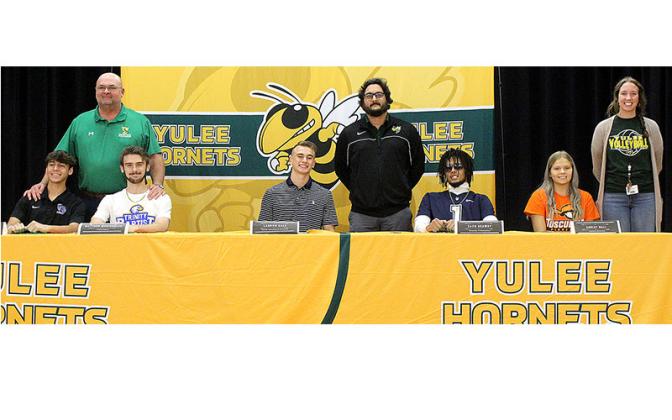 Taylor Whelan and Matthew McNicholas, with head boys soccer coach Richard Barnard, Landon Hale and Zack Drawdy, with head football coach Kyle Dougherty, and Ashley Hall, with head volleyball coach Jenna Nelson, from left, are pictured after the five signed national letters of intent Wednesday. Photo by Beth Jones/News-Leader