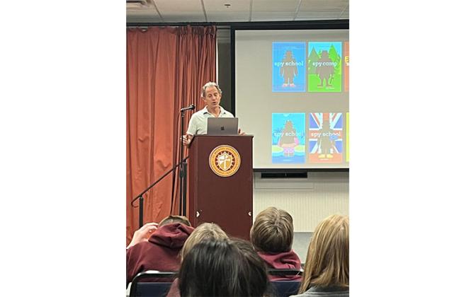 Author Stuart Gibbs talks with St. Michael Academy students about his book series.