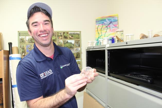 Dr. Taylor Clem with one of the many specimens of bugs, branches and animals studied by the UF Extension office. “I love my job,” he said. “Some days you get a little head spun because you have so many things going on at the same time, but that’s OK. I will probably have someone call me today to ask about a palm tree or a person bring a bug sample in. Every day is different and that’s why I love it.”