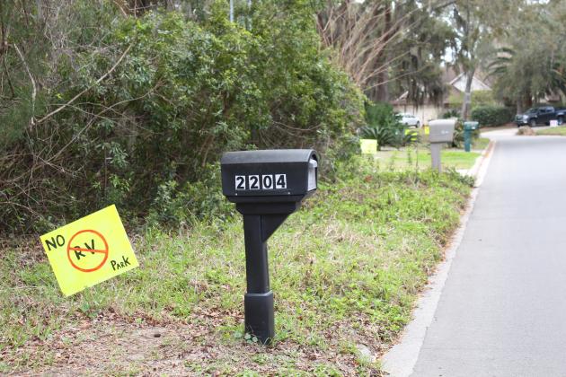 Signs on lawns in the Pirates Bay subdivision protest Breakers RV Park. Photo by Julia Roberts