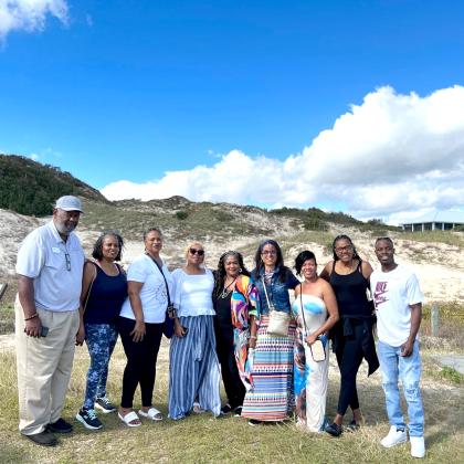Coast One Tour Group in front of “Nana” on American Beach. Largest dune in Florida.