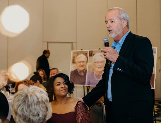 Our own “Elvis,” Lane Mashburn, owner of Amelia Auto Mart, serenades the crowd with “Can’t Help Falling in Love,” during NCCCOA’s annual gala. Photo by Page Teahan Photography