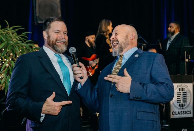 Aaron Bean, left, and John Drew, gala auctioneer and emcee, respectively, kept the crowd — and themselves — engaged during the festivities. Photo by Page Teahan Photography