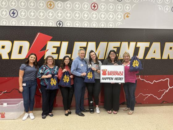 Pictured are, from left, Kayla Vanderlaan, Gator Bowl; Danielle Loudermilk, principal at Hilliard Elementary; Whitney Jones, assistant principal at Hilliard Elementary; Gil Langley, Amelia Island Convention & Visitors Bureau; Katie Cox, Gator Bowl; Maurie Dugger, Amelia Island Convention & Visitors Bureau; and Susan Evans, First Coast Blessings in a Backpack. Submitted photo