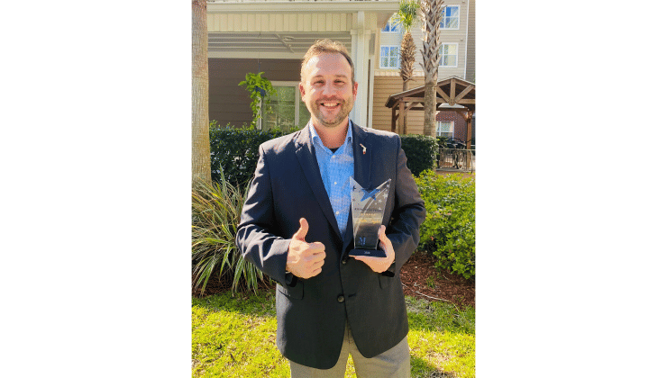 Justin Taylor was presented with the Rising Star Award by the President of Meyer Jabara Hotels. Submitted photo