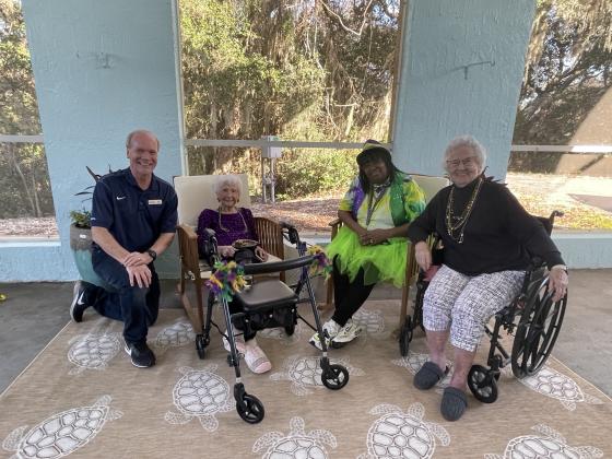 Brett Wood, president and CEO of Toyota Material Handling, poses for a photo with residents. Photo courtesy of Toyota material Handling North America