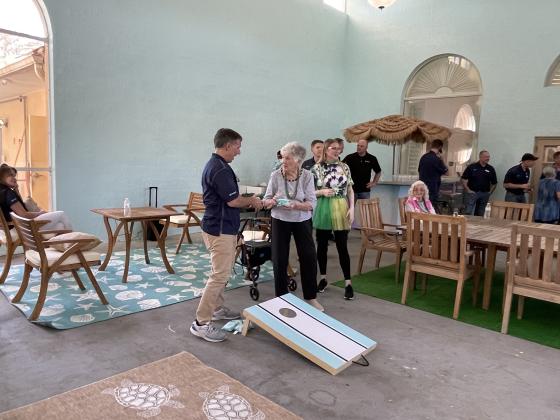 Steve VanNostrand playing cornhole with a resident. Photo courtesy of Toyota material Handling North America