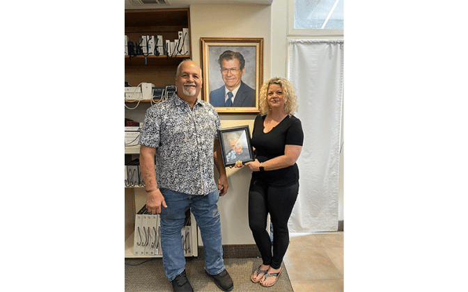Wallace and Arlene Rowland with pictures of their mother and father. Photo by Sean Rosenthal