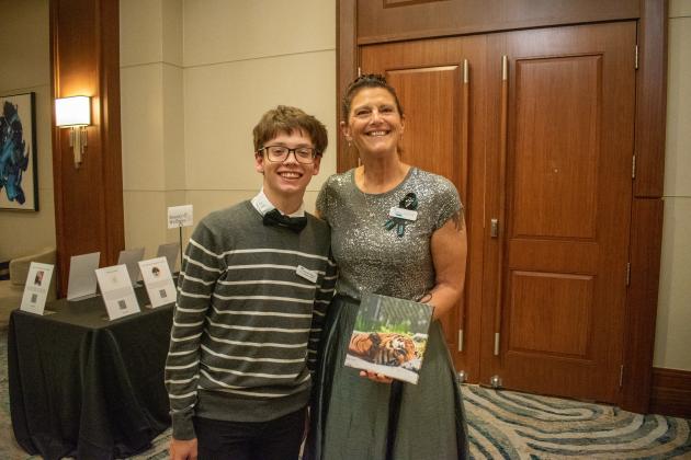 Take Stock Nassau senior Jeremiah Peterson (West Nassau), poses with mentor Vicki Arpin. Arpin purchased Peterson’s tiger photo from the silent auction. Submitted photo