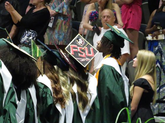 Graduates at both ceremonies decorated their caps in the various colors of their respective universities and one that lamented how high school in real life was nothing like High School Musical. Penny Glackin/Holly Dorman/News-Leader