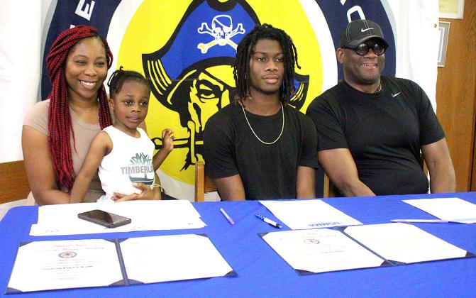 Jamieson Keith, Brooks Rohe and Andre Lucas signed national letters of intent to play their respective sport in college. Keith is a baseball player at Fernandina Beach High School, and Rohe and Lucas played football for the Pirates. They are pictured April 27 with friends, family and coaches at the spring signing day in the media center. Photo by Beth Jones/News-Leader