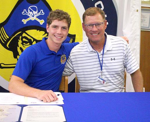 Jamieson Keith, Brooks Rohe and Andre Lucas signed national letters of intent to play their respective sport in college. Keith is a baseball player at Fernandina Beach High School, and Rohe and Lucas played football for the Pirates. They are pictured April 27 with friends, family and coaches at the spring signing day in the media center. Photo by Beth Jones/News-Leader
