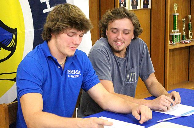 Jamieson Keith, Brooks Rohe and Andre Lucas signed national letters of intent to play their respective sport in college. Keith is a baseball player at Fernandina Beach High School, and Rohe and Lucas played football for the Pirates. They are pictured April 27 with friends, family and coaches at the spring signing day in the media center. Photo by Beth Jones/News-Leader