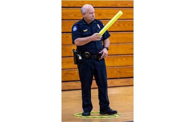 Fernandina Beach police officers stopped by the Fernandina Beach High School gym Tuesday and played dodgeball with the children attending the P.E. Camp this summer. Photos by Penny Glackin/Special
