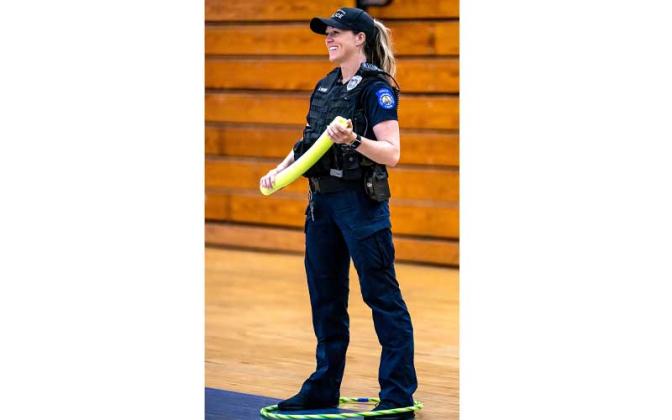 Fernandina Beach police officers stopped by the Fernandina Beach High School gym Tuesday and played dodgeball with the children attending the P.E. Camp this summer. Photos by Penny Glackin/Special