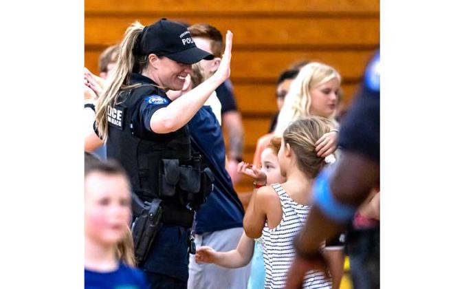 Fernandina Beach police officers stopped by the Fernandina Beach High School gym Tuesday and played dodgeball with the children attending the P.E. Camp this summer. Photos by Penny Glackin/Special