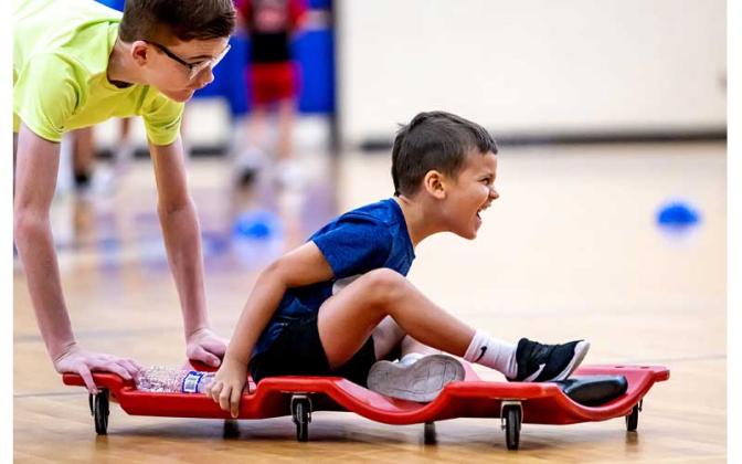 Fernandina Beach police officers stopped by the Fernandina Beach High School gym Tuesday and played dodgeball with the children attending the P.E. Camp this summer. Photos by Penny Glackin/Special