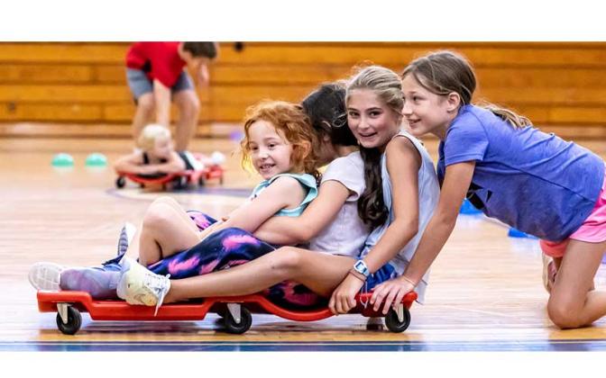 Fernandina Beach police officers stopped by the Fernandina Beach High School gym Tuesday and played dodgeball with the children attending the P.E. Camp this summer. Photos by Penny Glackin/Special