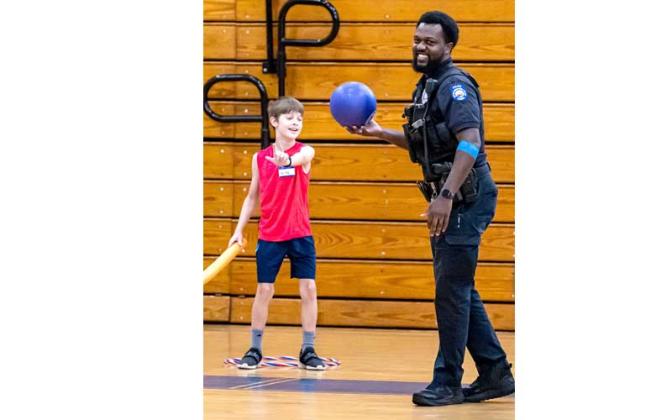 Fernandina Beach police officers stopped by the Fernandina Beach High School gym Tuesday and played dodgeball with the children attending the P.E. Camp this summer. Photos by Penny Glackin/Special