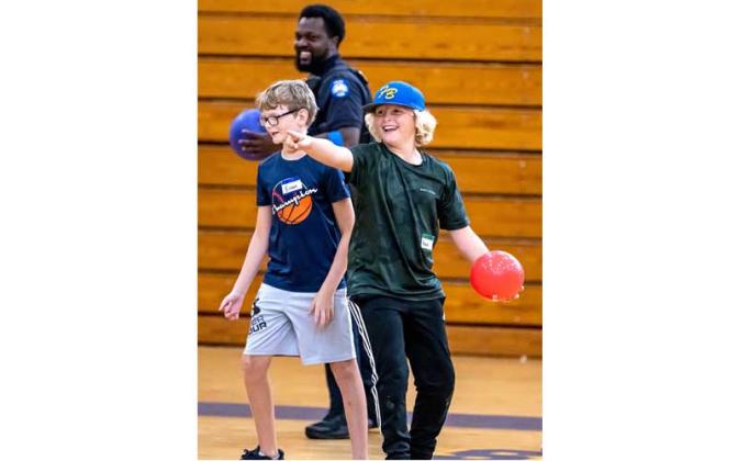 Fernandina Beach police officers stopped by the Fernandina Beach High School gym Tuesday and played dodgeball with the children attending the P.E. Camp this summer. Photos by Penny Glackin/Special