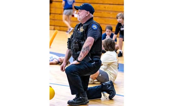 Fernandina Beach police officers stopped by the Fernandina Beach High School gym Tuesday and played dodgeball with the children attending the P.E. Camp this summer. Photos by Penny Glackin/Special