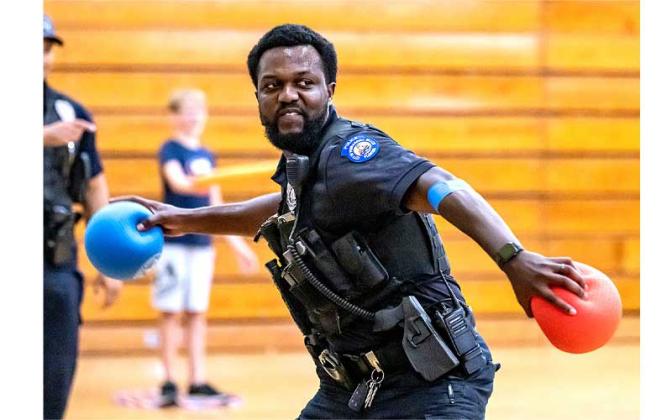 Fernandina Beach police officers stopped by the Fernandina Beach High School gym Tuesday and played dodgeball with the children attending the P.E. Camp this summer. Photos by Penny Glackin/Special