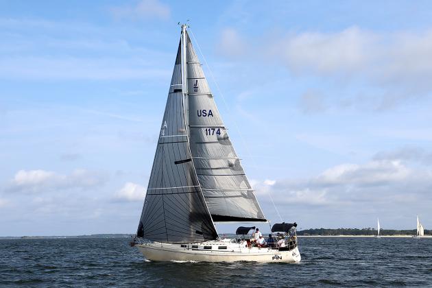 Tiger Tale and Misty during Saturday’s Amelia Island Sailing Club race, left. The fleet on a windward beat, right. Submitted photos