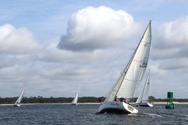 Tiger Tale and Misty during Saturday’s Amelia Island Sailing Club race, left. The fleet on a windward beat, right. Submitted photos