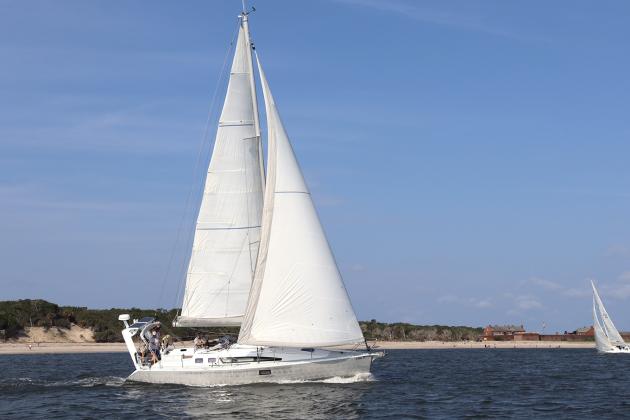 Tiger Tale and Misty during Saturday’s Amelia Island Sailing Club race, left. The fleet on a windward beat, right. Submitted photos