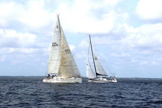 Tiger Tale and Misty during Saturday’s Amelia Island Sailing Club race, left. The fleet on a windward beat, right. Submitted photos