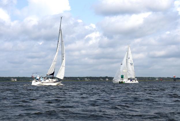 Tiger Tale and Misty during Saturday’s Amelia Island Sailing Club race, left. The fleet on a windward beat, right. Submitted photos