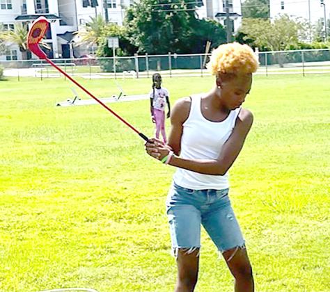 Youth take a swing at golf. Submitted photo