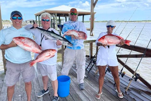 Matt Hampton, Greg Cook, Bill Fassbender and Pam Cook, from left, are pictured with a big red snapper and kingfish catch. Photo by Terry Lacoss